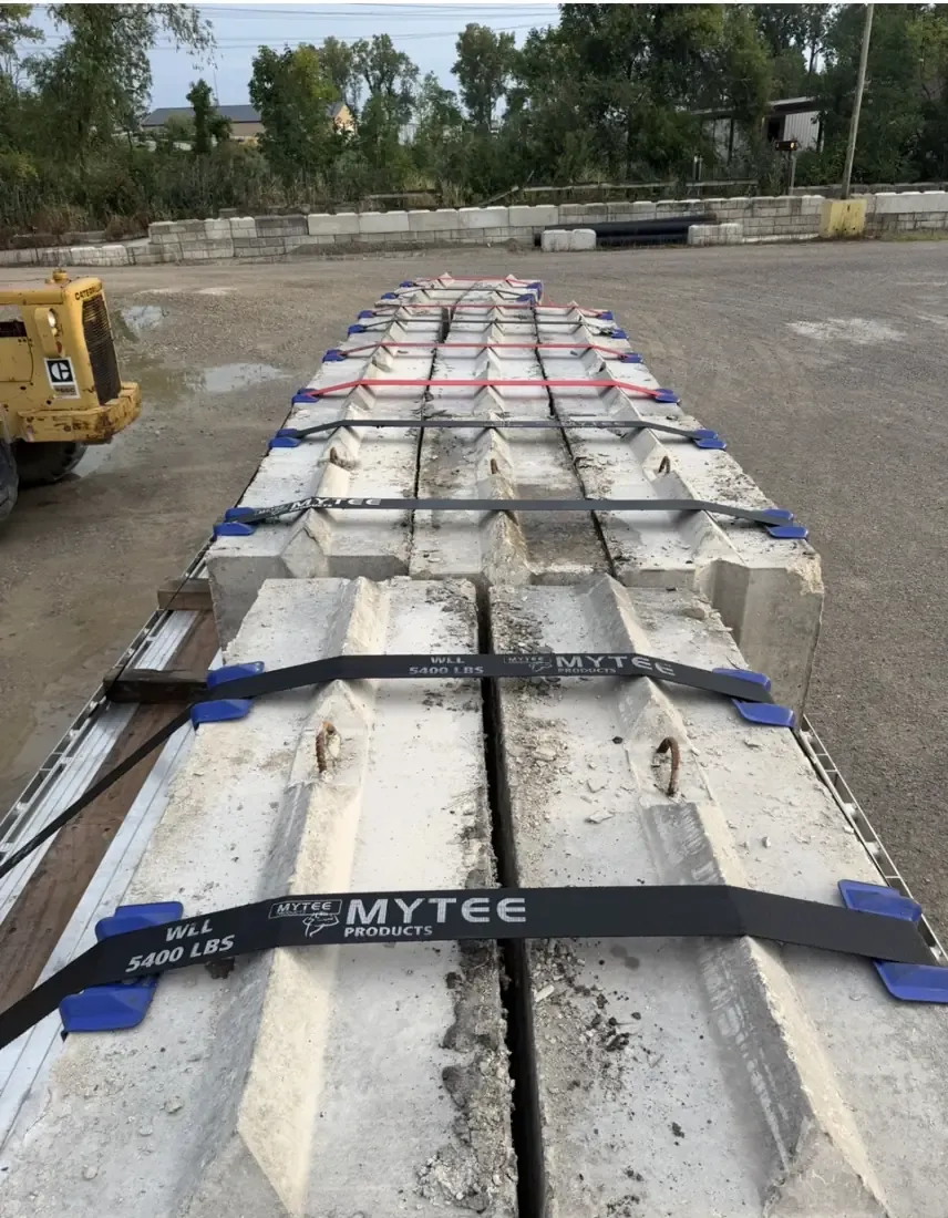 Top view of interlocking concrete blocks on a trailer, showing the cast lug and the lifting loops