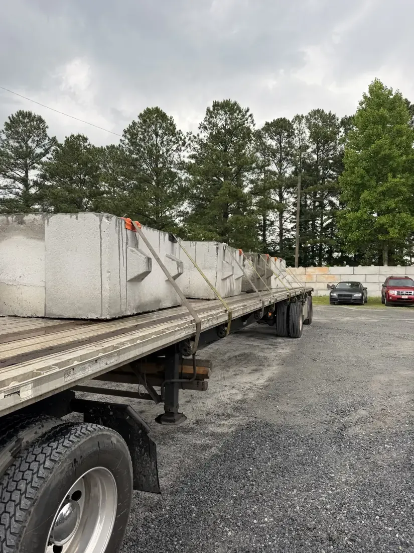 Concrete blocks lined up on a flatbed trailer, ready for a perimeter run